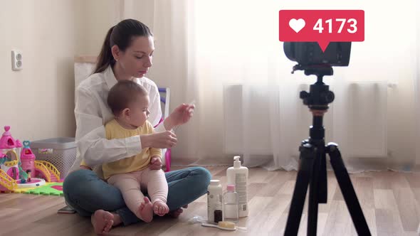 Young Pretty Mother with Baby Recording Vlog or Doing Live Stream and Going Virel with Liked Counter