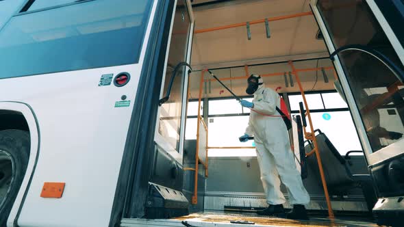 Sanitary Inspector Is Spraying Chemicals in the Bus