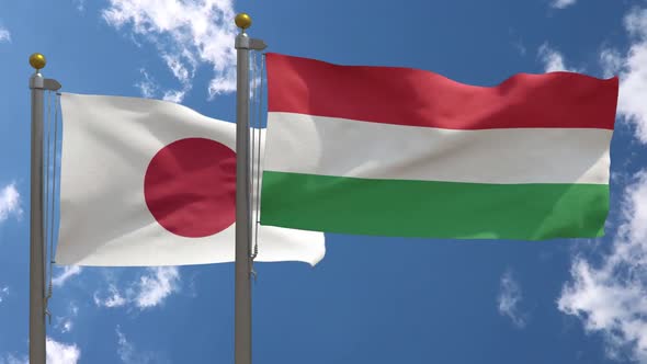 Japan Flag Vs Hungary Flag On Flagpole