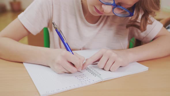 Pretty Schoolgirl Doing Mathematics Homework