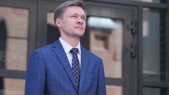 Serious Businessman Standing Outside Office