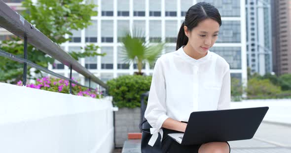 Woman work on laptop computer at outdoor