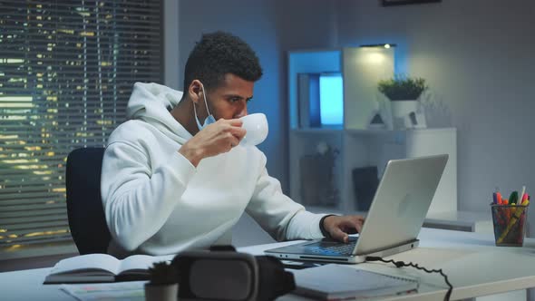 Multiracial Man on Quarantine Working Home Late at Night