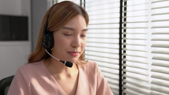 Competent Female Operator Working on Computer and While Talking with Clients