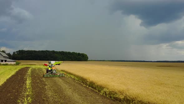 Green Tractor Working in a Field 