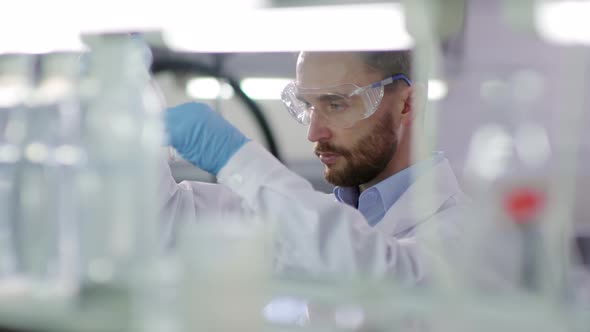 Scientist Carrying out Experiment in Laboratory alt