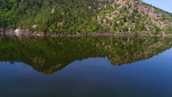 Forest and mountain reflected in the lake.