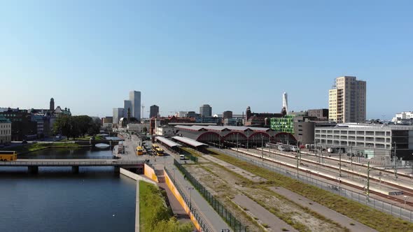 Drone flying towards Malmö Central Station in daytime. Turning torso in background