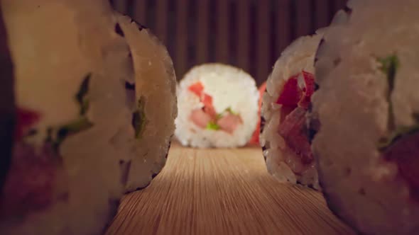 Zoom in Slide Video of Japanese Sushi Roll on Wooden Background