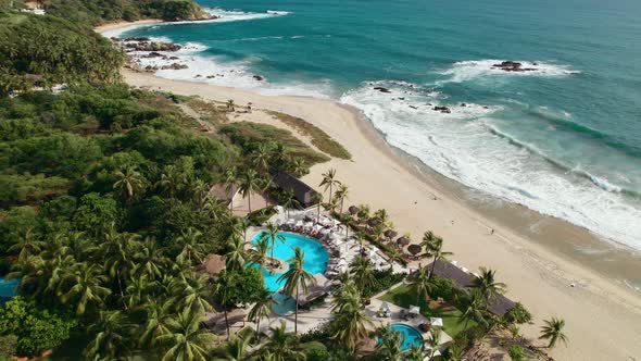 Stunning resort with a swimming pool overlooking a white sand beach in Oaxaca Mexico