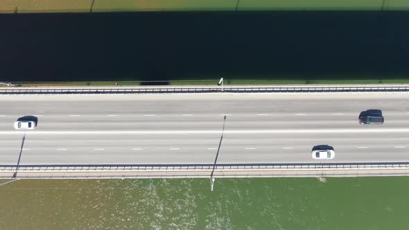 Aerial filming. Cars go over the bridge over the Tom river, Tomsk, Siberia, Russia