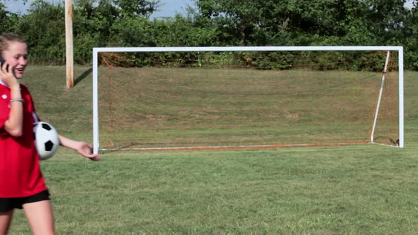 Girl soccer player with cellphone