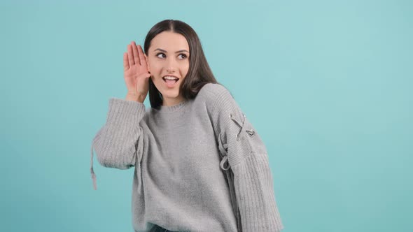 Close Up of a Curious Young Woman Try To Hear You with Hand Near Ear.