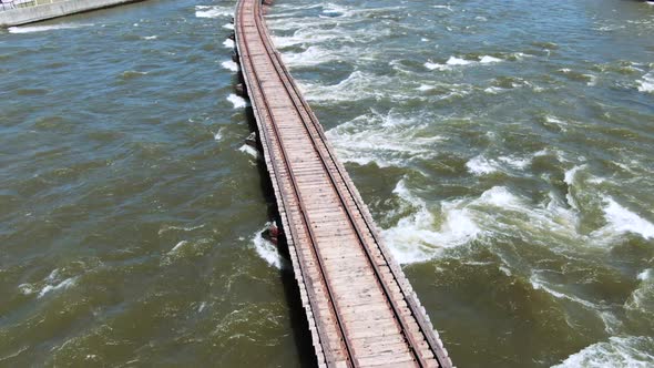 Still shot of train tracks across Fox River in Kaukauna Wisconsin, river raging