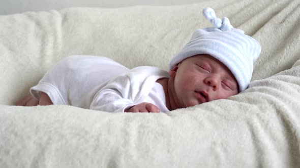 Closeup Newborn Baby Face Portrait Early Days Sleeping Sweetly On Tummy Beige White Background