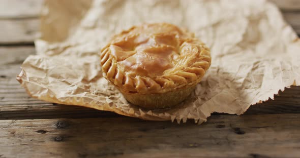 Video of pie seen from above on wooden background