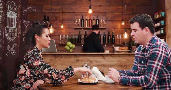 Zoom in Shot of Beautiful Couple Drinking Coffee in Vintage Rustic Coffee Shop Pub Restaurant