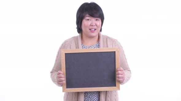 Surprised Overweight Asian Woman Holding Blackboard Ready for Winter