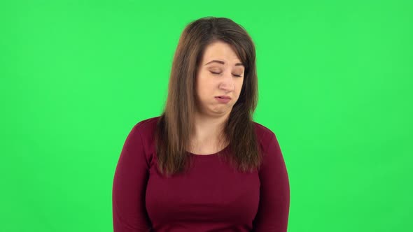 Portrait of Pretty Girl Is Showing Disgust for Bad Smell or Taste. Green Screen