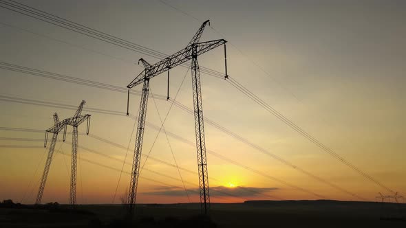 High Voltage Towers with Electric Power Lines at Sunset