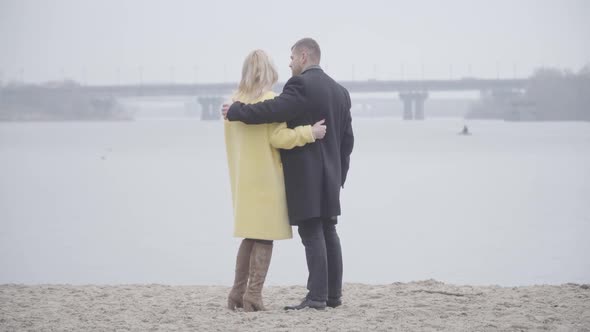 Wide Shot of Loving Adult Couple Standing on Riverbank and Talking