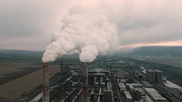 Aerial View of Oil and Gas Petrochemical Base Industry and Oil Refinery at Sunset in Cloudy Weather