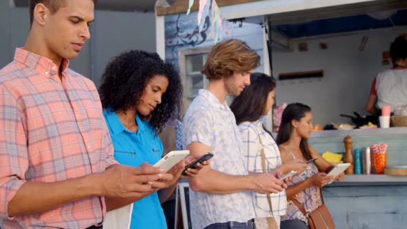 Friends standing with mobile phone and digital tablet