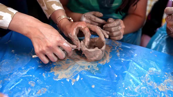 Children Make Shapes From Ceramic Mud