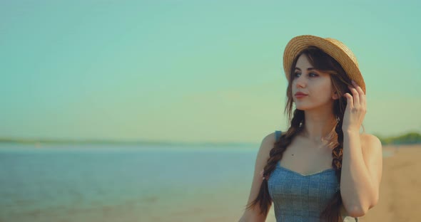 Beautiful Woman Walks By the Sea and Enjoys Nature