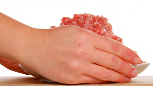 Raw minced pork in a white ceramic cup