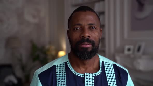 Portrait of Black Bearded Man Indoors, Handsome Adult Guy Is Looking at Camera Calmly