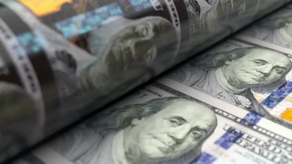 Close-up of US Dollars Press Machine Printing 100 USD Banknotes alt
