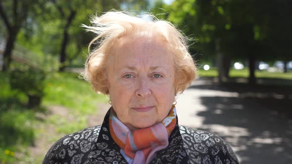 Portrait of Beautiful Elderly Woman Seriously and Pensive Looking at Camera