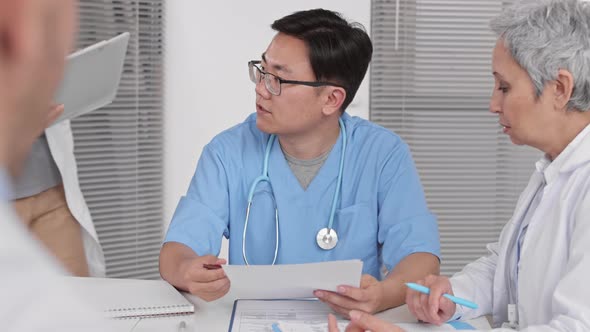 Asian Doctor Signing Papers