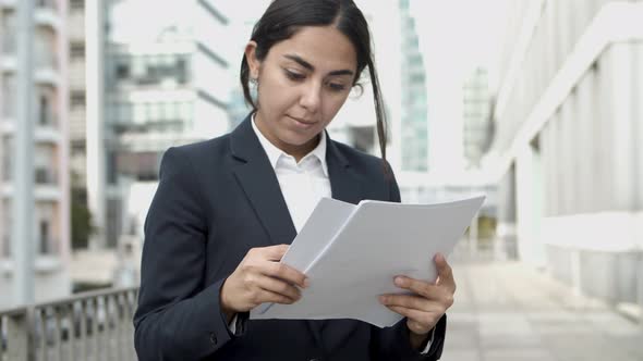 Young Businesswoman Reading Papers