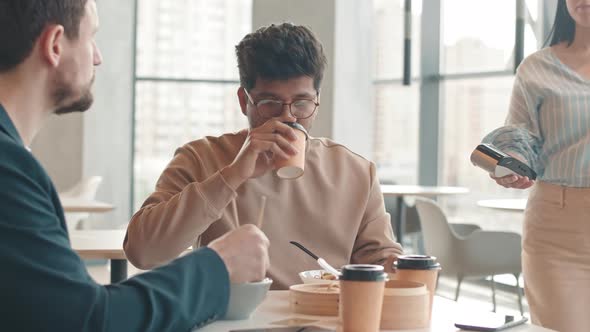 Biracial Man Paying for Lunch with Smartphone at Food Court