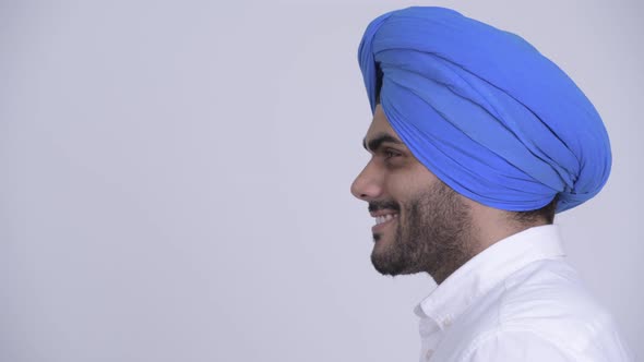 Closeup Profile View of Happy Young Bearded Indian Sikh Man Smiling