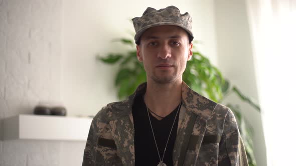 Portrait of a Man in Military Fatigues Face to Camera