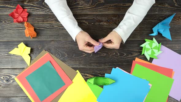 Mans Hands Doing Origami Flower.