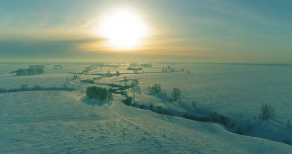 Aerial View of Cold Winter Landscape Arctic Field Trees Covered with Frost Snow Ice River and Sun