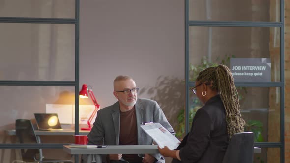 Senior Man Having Job Interview with Female Recruiter