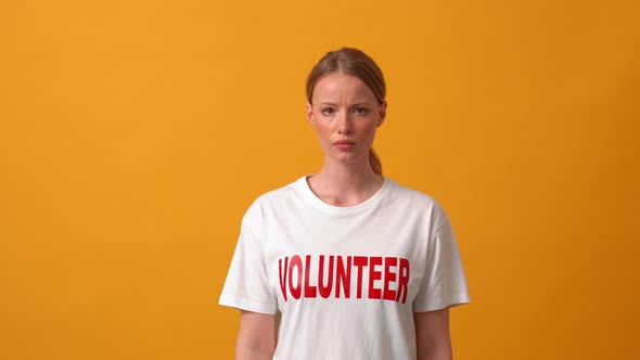 Worried woman volunteer looking at the camera