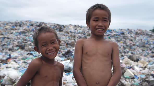 Happy Poor Children Standing With Garbage Dump