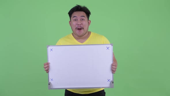 Happy Young Overweight Asian Man Holding White Board