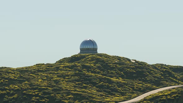 A modern astronomical observatory in a vast meadow valley during a day. 4KHD