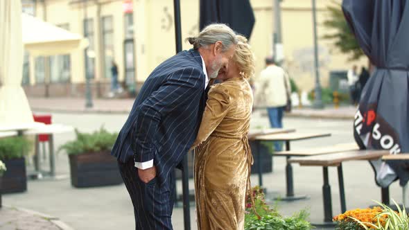 an Elderly Couple Walking Around the City