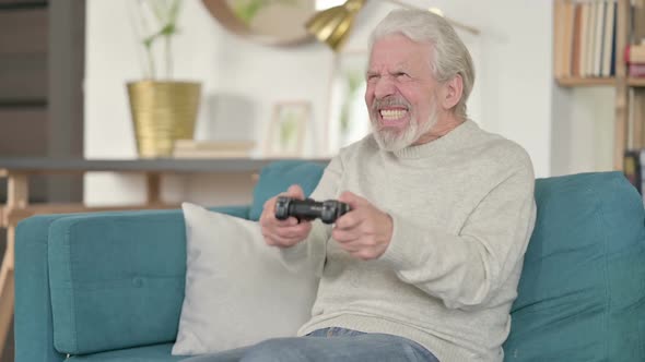 Excited Old Man Playing Video Game Winning