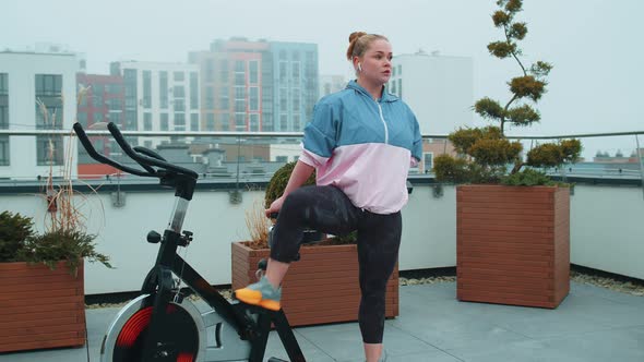 Woman Performs Aerobic Endurance Training Workout Cardio Routine on the Simulators Cycle Training