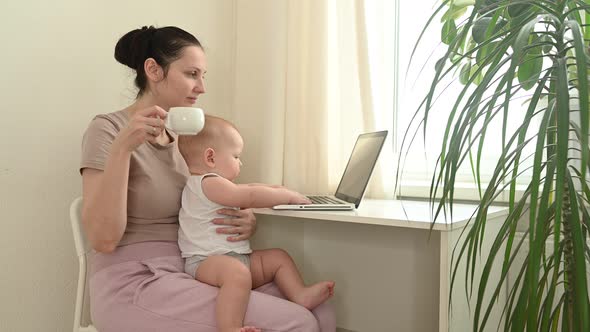 Young Mother Work Studying From Home with Laptop Computer During Quarantine Little Cute Toddler Baby