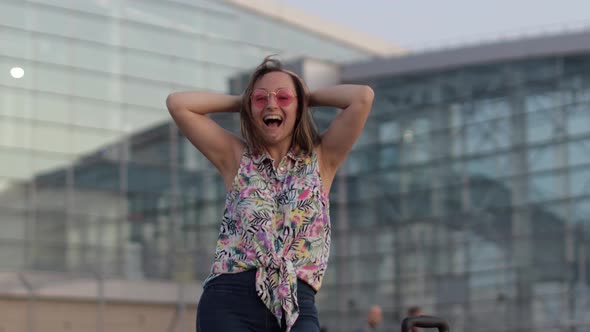 Joyful Tourist Woman Showing Yes Gesture with Raised Arms, Excited About Success Celebrating Victory